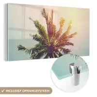 MuchoWow Glasschilderij 120x60 cm - Schilderij acrylglas - Palmboom - Zomer - Tropisch - Zon - Foto op glas - Schilderijen