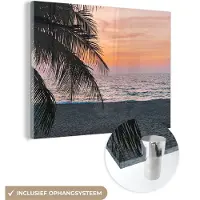 MuchoWow Glasschilderij 80x60 cm - Schilderij acrylglas - Palmboom - Strand - Zee - Avond - Foto op glas - Schilderijen