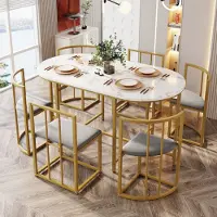 Flieks eettafelset, 7-delig, bestaande uit een eettafel met 6 stoelen. Keukenmeubelset voor de eetkamer, met beklede zitplaatsen. Eetkamerzet met een ovale eettafel, in de kleur goud