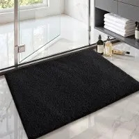 Unyqoos Zwarte antislip badmat van microvezel 60x90 cm voor ultiem comfort