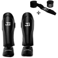 Joya SKINTEX Scheenbeschermers – Kickboksen/Muay Thai/MMA – Zwart/Wit – Maat M – Gegoten model, extra dikke padding – Inclusief Bandage