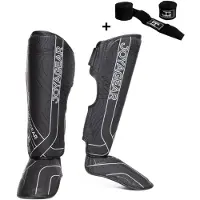 Joya ESSENTIAL Scheenbeschermers – Maat XL – Zwart/Wit – Kickboksen/Muay Thai/MMA – Ergonomische pasvorm, schokabsorberende padding – Inclusief Bandage