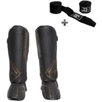 Joya ESSENTIAL Scheenbeschermers – Kickboksen/Muay Thai/MMA – Zwart/Goud – Maat XL – Ergonomische pasvorm, schokabsorberende padding – Inclusief Bandage